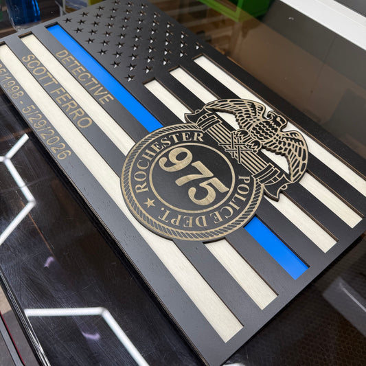 Custom engraved Thin Blue Line wood flag with the Rochester Police Department badge 975, a blue acrylic line and engraved stripe text